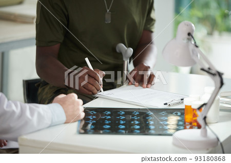 Military Man Signing Medical Document 93180868