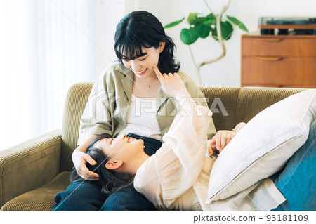 Same-sex partner (female) relaxing in the room 93181109