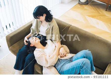 Same-sex partner (female) relaxing in the room 93181111