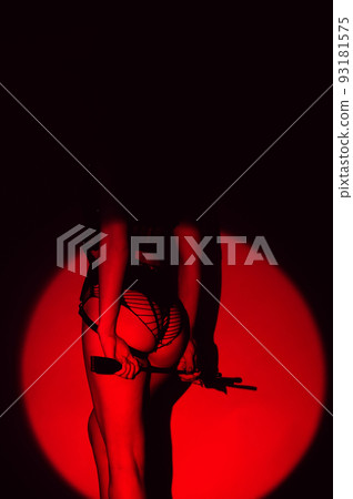 woman with a sexy ass in underwear and panties holds a leather flogger whip in her hands for BDSM sex 93181575
