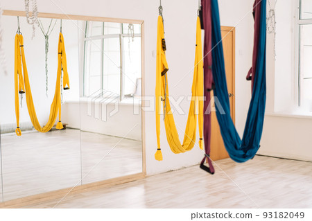 Hanging hammocks in front of a mirror in the fly yoga room 93182049