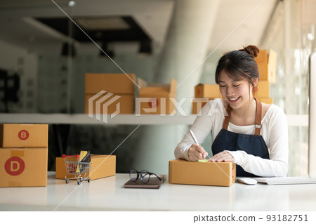 Startup SME small business entrepreneur of freelance asian woman using a laptop with box Cheerful success online marketing packaging box and delivery SME idea concept. Startup SME small business entrepreneur of freelance asian woman using a laptop with box Cheerful success online marketing packaging box and delivery SME idea concept. 93182751