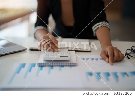 Businesswoman accountant or financial expert analyze business report graph and finance chart at corporate office. Concept of finance economy, banking business and stock market research. 93183200