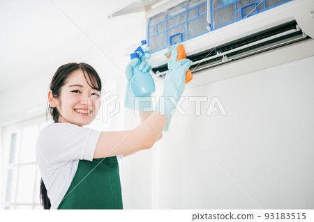 Cleaning business woman cleaning air conditioner 93183515