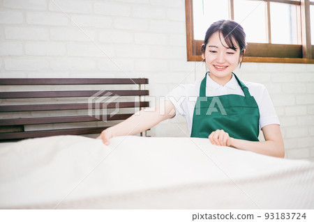 Housekeeping woman who makes the bed 93183724