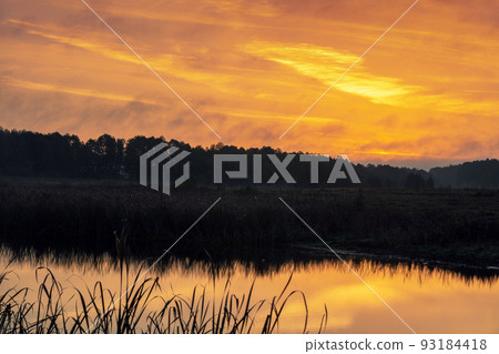 Rural nature landscape. Sunset over the lake. Magic colorful sunset in the countryside. Rural landscape in the evening. Beautiful summer nature Rural nature landscape. Sunset over the lake. Magic colorful sunset in the countryside. Rural landscape in the evening. Beautiful summer nature 93184418