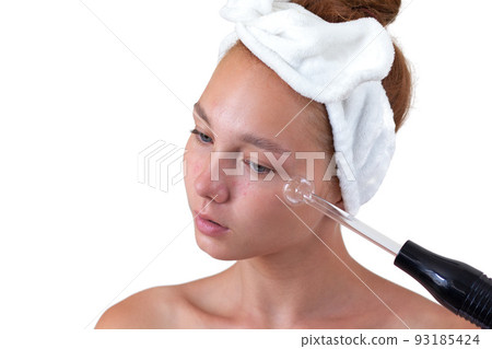 Woman without make up with acne holding darsonval Woman without make up with acne holding darsonval 93185424
