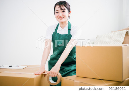 Female working on moving (packing) 93186031