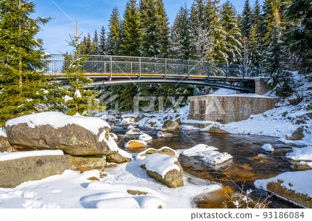 Pedestrian broder bridge over Jizera River in winter 93186084