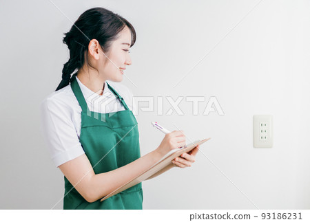 Female checking the power plug outlet Female checking the power plug outlet 93186231