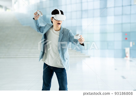 A man experiencing virtual reality in VR A man experiencing virtual reality in VR 93186808