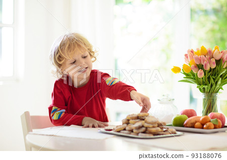 Child eating breakfast. Kid drinking milk. Child eating breakfast. Kid drinking milk. 93188076