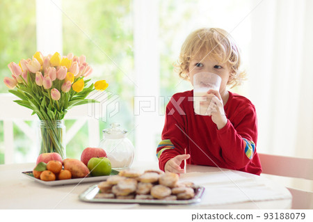 Child eating breakfast. Kid drinking milk. Child eating breakfast. Kid drinking milk. 93188079
