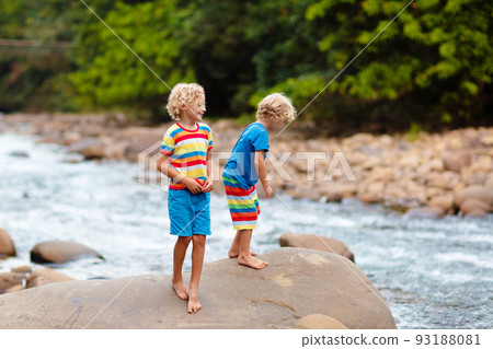 Child hiking in mountains. Kids at river shore. Child hiking in mountains. Kids at river shore. 93188081