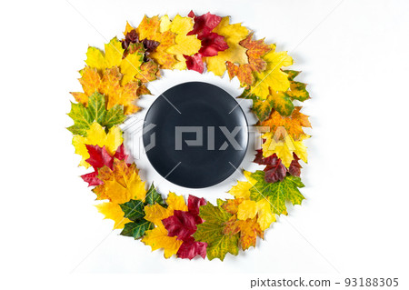 Autumn table setting with bright colorful leaves and black plate. Flat lay. 93188305