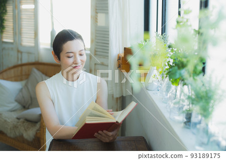 Woman by the window very short Woman by the window very short 93189175