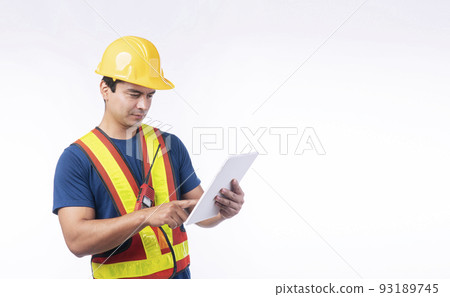Handsome confident craftsman wear yellow helmet hard hat safety with walkie talkie use touch screen 93189745