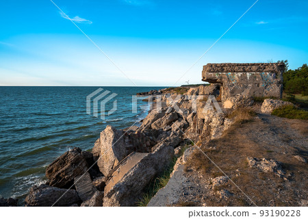 Ruins of bunkers on the beach of the Baltic sea, part of an old fort in the former Soviet base Karosta in Liepaja, Latvia. Sunset landscape. 93190228