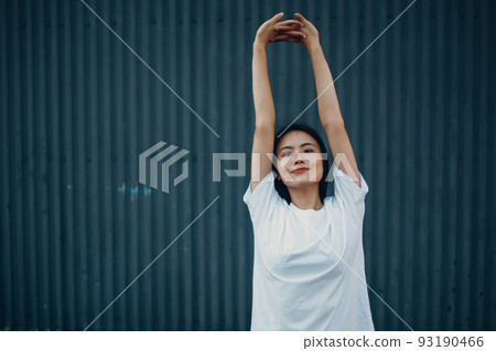 Asian young woman doing qigong yoga stretching pilates exercise summer outdoor. 93190466