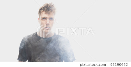 Smoke enveloped young man. Model looking at camera isolated over white background with clouds of smoke. Concept of mental health, art, emotions 93190632