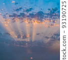 Blue and orange sunset sky with rays of sun going through clouds. 93190725