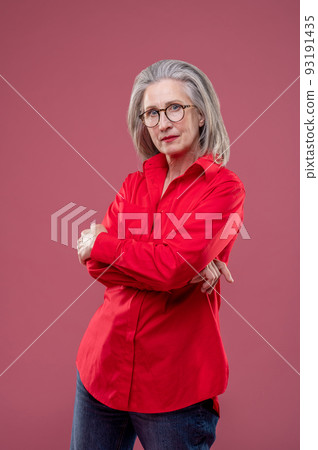 Woman in red shirt standing with her arms crossed Woman in red shirt standing with her arms crossed 93191435