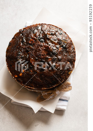 Christmas cake or chocolate pudding with fruits and nuts. Top view. Christmas cake or chocolate pudding with fruits and nuts. Top view. 93192159