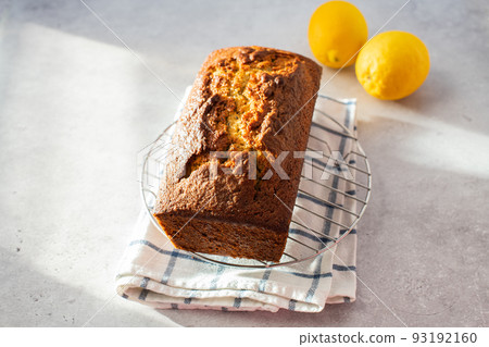 Lemon cake on a cooling rack on a gray background. Lemon cake on a cooling rack on a gray background. 93192160