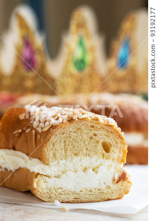 Roscon de Reyes - piece of festive Spanish baking. Close up. Roscon de Reyes - piece of festive Spanish baking. Close up. 93192177