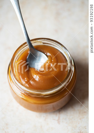Homemade creamy caramel in a jar. Close up. Homemade creamy caramel in a jar. Close up. 93192198