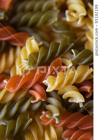 Fusilli colorful twisted pasta background. 93192199