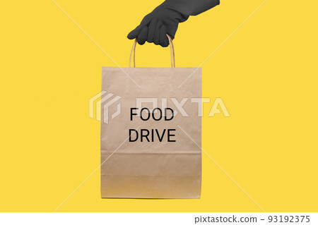 Delivery man holding craft paper packet in rubber gloves with copy space. Fast and free Delivery. Online shopping and Express delivery. 93192375