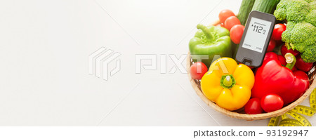 Glucometer with fresh vegetables. Diabetes concept Glucometer with fresh vegetables. Diabetes concept 93192947