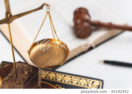 Scale and judge gavel on a wooden desk 93192952