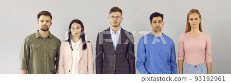Team of young business people with serious facial expressions standing in studio 93192961