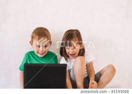 Boy and girl use laptop while sitting at home 93193088