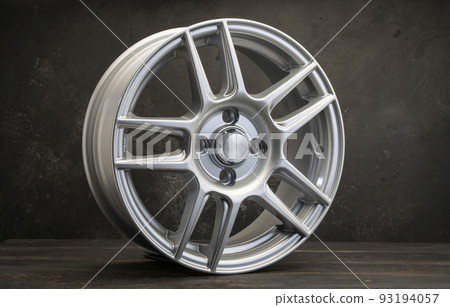 new grey alloy wheels on a dark textured black background. a wheel for a car new grey alloy wheels on a dark textured black background. a wheel for a car 93194057