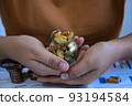 Two hand handle raw gold stone. concept of of asset money debt mangement. 93194584