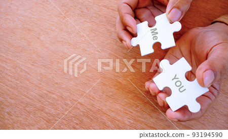 wo hand put wo jigsaw puzzle togeher. With word of you and me. wo hand put wo jigsaw puzzle togeher. With word of you and me. 93194590