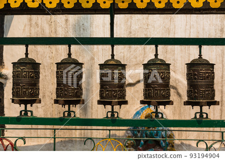 Prayer wheels at a Buddhist temple in a square in Kathmandu, Nepal Prayer wheels at a Buddhist temple in a square in Kathmandu, Nepal 93194904