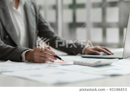 Business woman calculating the company's financial results and budget 93196853
