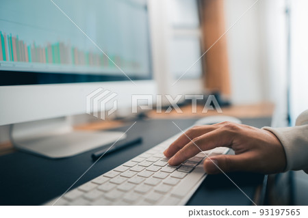 Man working on computer desk at home office 93197565