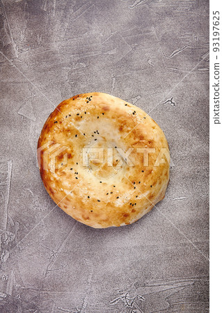 Delicious fresh tandir flatbread with black and white sesame seeds. National traditional Asian food 93197625