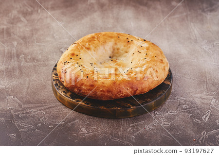 Delicious fresh tandir flatbread with black and white sesame seeds. National traditional Asian food 93197627