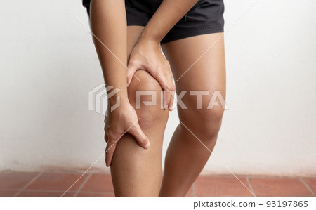 Woman hand massage physiotherapy her knee is sore and numb, exhausted, tingling. Guillain-Barre Syndrome, a side effect of the Covid vaccination Woman hand massage physiotherapy her knee is sore and numb, exhausted, tingling. Guillain-Barre Syndrome, a side effect of the Covid vaccination 93197865