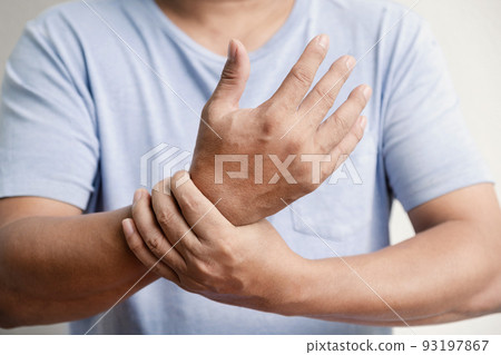 Man hand massage physiotherapy wrist is sore and numb, exhausted, tingling. Guillain-Barre Syndrome, a side effect of the Covid vaccination 93197867