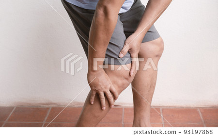 man hand massage physiotherapy her knee is sore and numb, exhausted, tingling. Guillain-Barre Syndrome, a side effect of the Covid vaccination 93197868