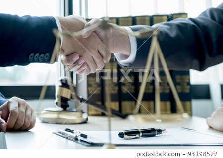 Handshake after Lawyer providing legal consult business dispute service to the man at the office with justice scale and gavel hammer Handshake after Lawyer providing legal consult business dispute service to the man at the office with justice scale and gavel hammer 93198522