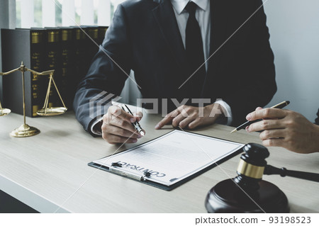 Lawyer hand holding pen and providing legal consult business dispute to the man Lawyer hand holding pen and providing legal consult business dispute to the man 93198523
