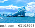A huge piece of translucent blue and turquoise ice is a beautiful iceberg that broke away from a glacier in the ocean off the coast of Iceland 93198993